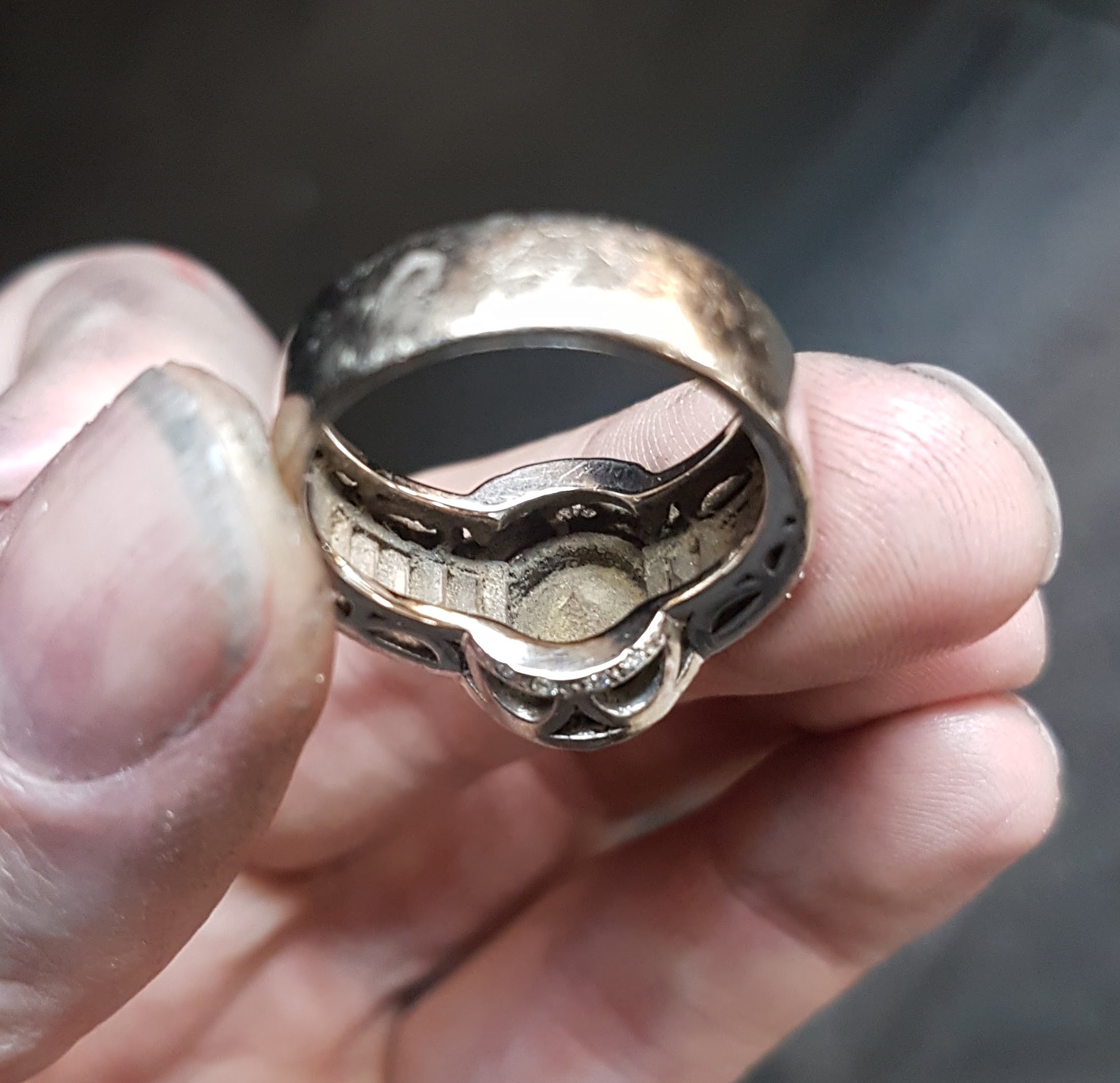 Dirt underneath the settings in a ring