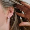 Spiral horn earrings on model